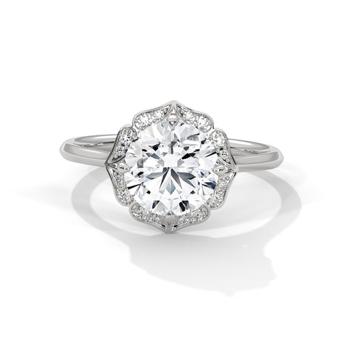 Round brilliant lab-grown diamond engagement ring featuring a scalloped floral halo and a polished white gold cathedral band.