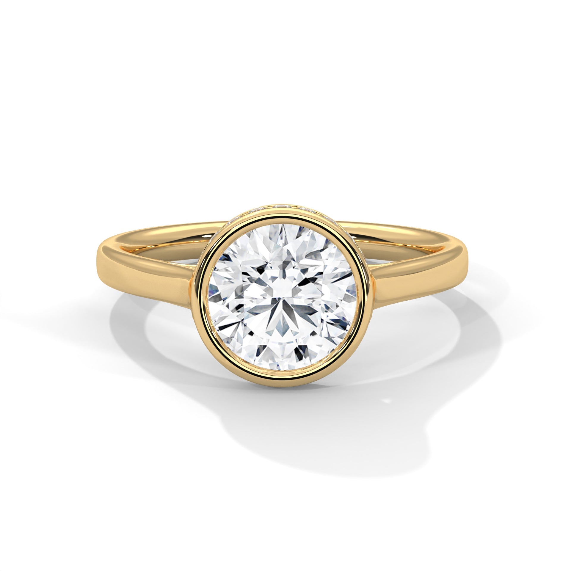 Round brilliant lab-grown diamond bezel solitaire engagement ring in solid 14k yellow gold.