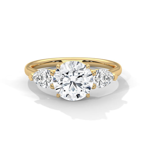 Round brilliant lab-grown diamond engagement ring with pear side stones in 14k yellow gold.