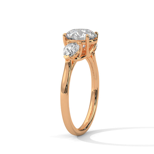 Perspective view of a round and pear-cut lab-grown diamond ring in rose gold.