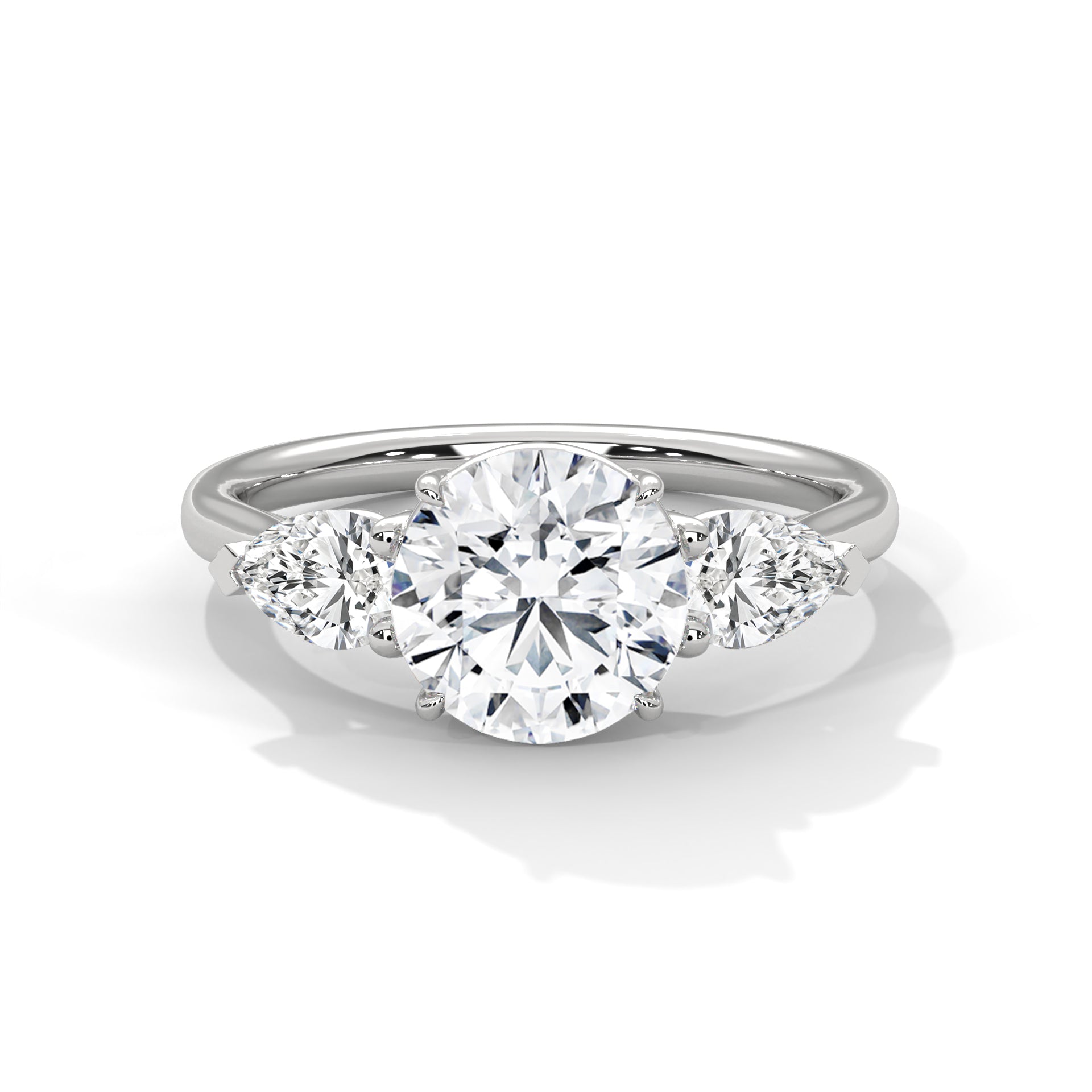 Three-stone lab-grown diamond engagement ring with round center and pear side stones in white gold.