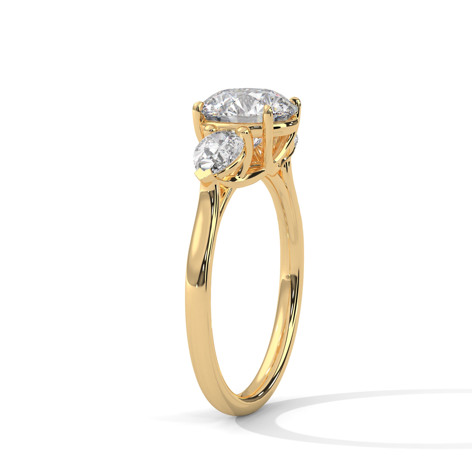 Angled shot of a three-stone diamond engagement ring in yellow gold.