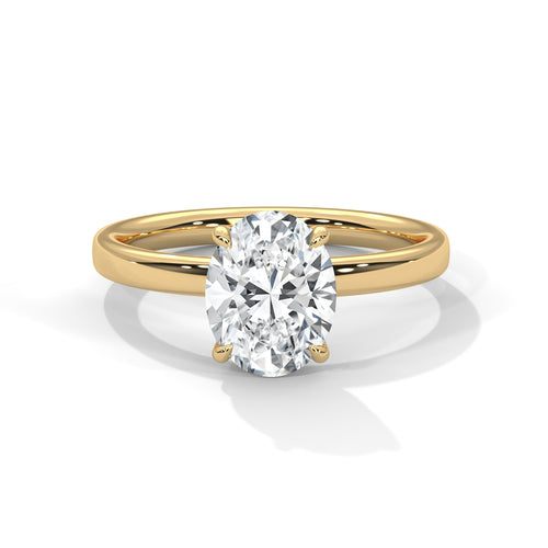 Oval solitaire plain band engagement ring in yellow gold, angled front view showing center stone and prong setting