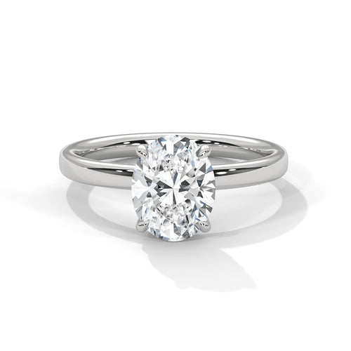 Oval solitaire plain band engagement ring in white gold, side profile view showing clean smooth band