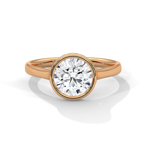 Round brilliant lab-grown diamond bezel solitaire engagement ring in solid 18k rose gold.
