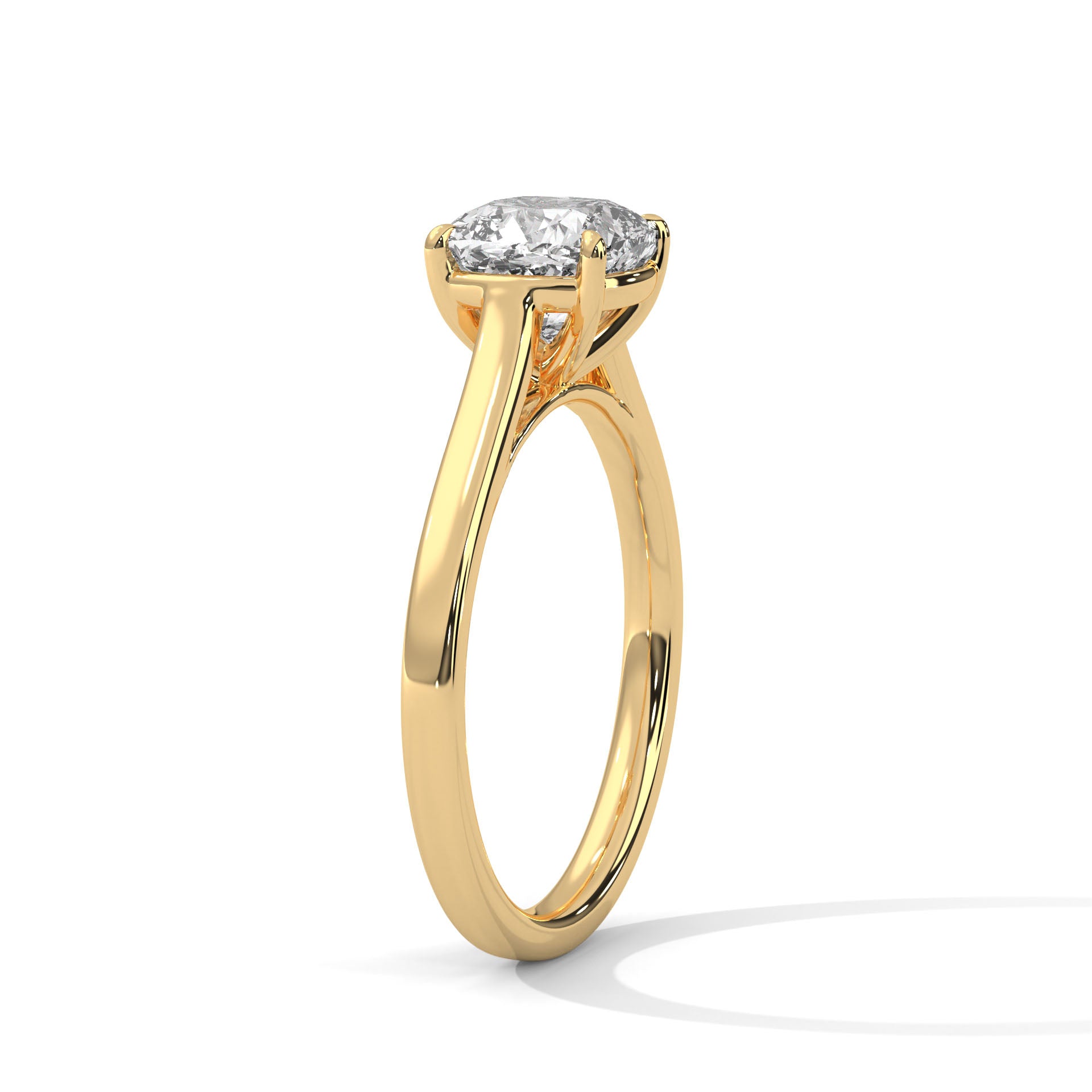 Angled perspective of a cushion cut solitaire ring in yellow gold highlighting the light-reflective sloped band.