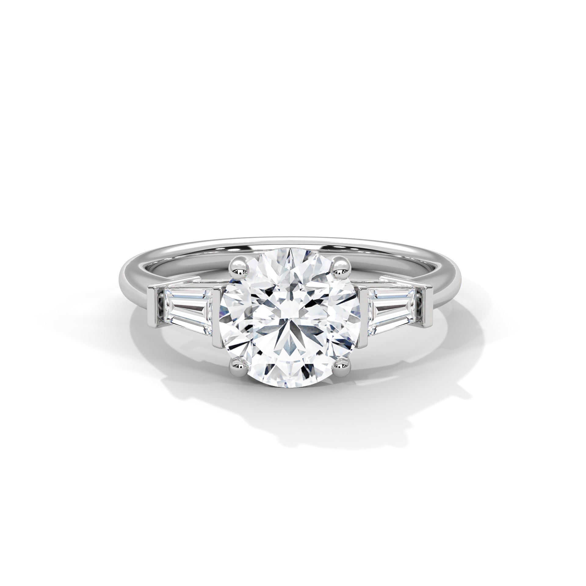 Front view of a solid white gold three-stone engagement ring showcasing a brilliant round center diamond and two tapered baguette side stones.