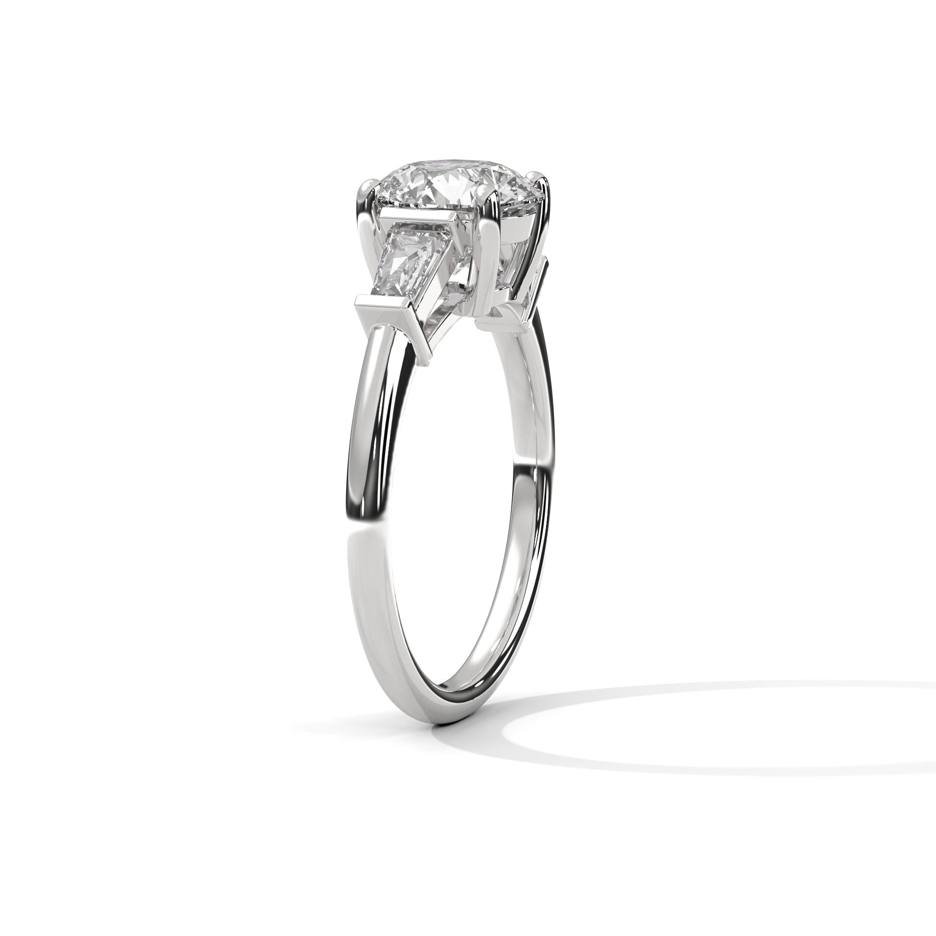 Three-quarter angled view of the polished white gold three-stone ring highlighting the clean lines of the tapered baguette accent stones.