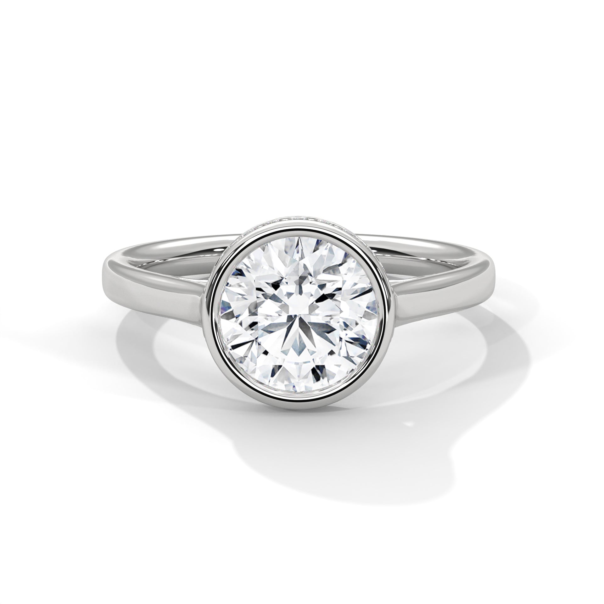 Round brilliant lab-grown diamond engagement ring inside a smooth protective bezel setting on a tapered white gold cathedral band.