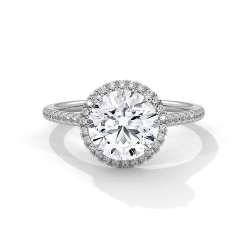 Round brilliant lab-grown diamond halo engagement ring with a pavé-set diamond band in solid white gold.
