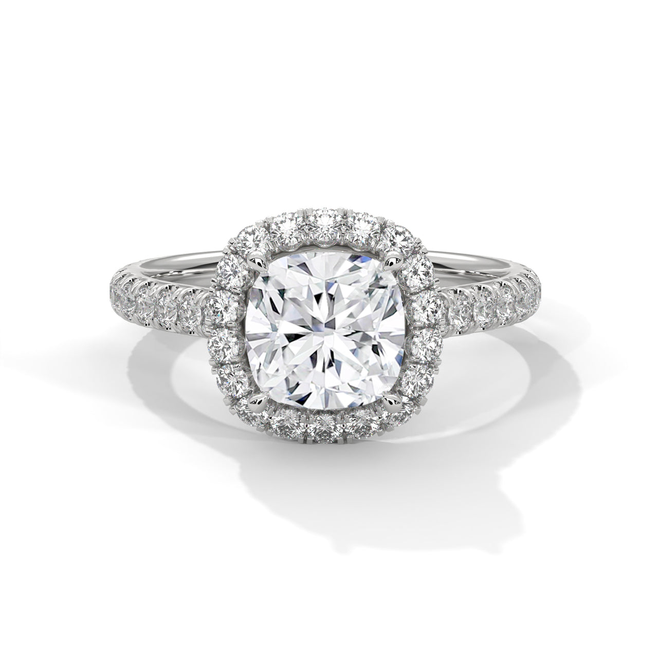 Cushion cut lab-grown diamond solitaire engagement ring featuring a hidden halo collar and a polished white gold knife-edge band.