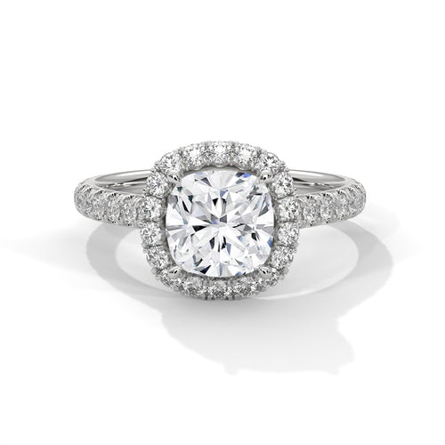 Cushion cut lab-grown diamond solitaire engagement ring featuring a hidden halo collar and a polished white gold knife-edge band.