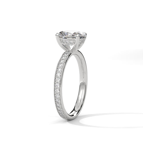 Oval hidden halo micropavé engagement ring in white gold, angled side view showing band profile