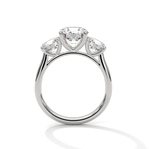 Round brilliant three-stone trilogy engagement ring in white gold, front-facing view showing three round brilliant stones