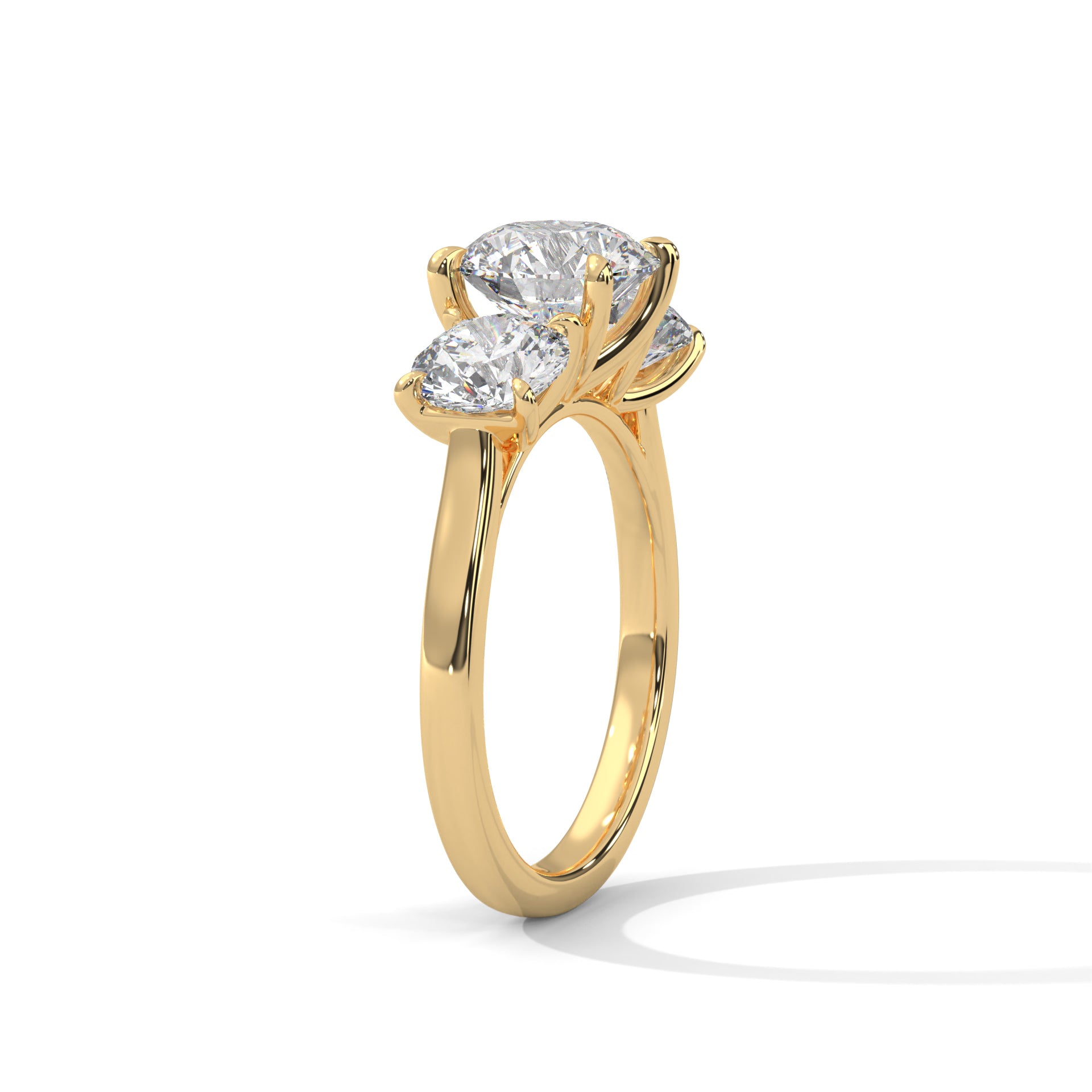 Round brilliant three-stone trilogy engagement ring in yellow gold, angled view highlighting center and side stones