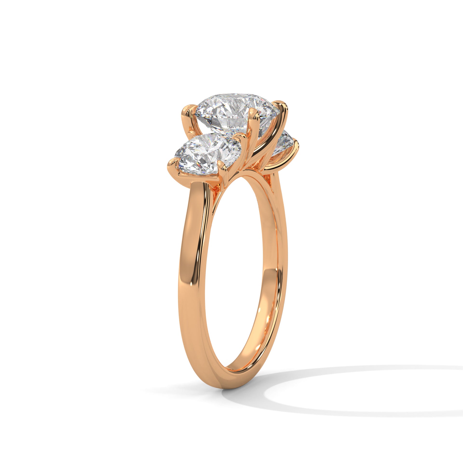 Round brilliant three-stone trilogy engagement ring in rose gold, side profile view showing crown height and band