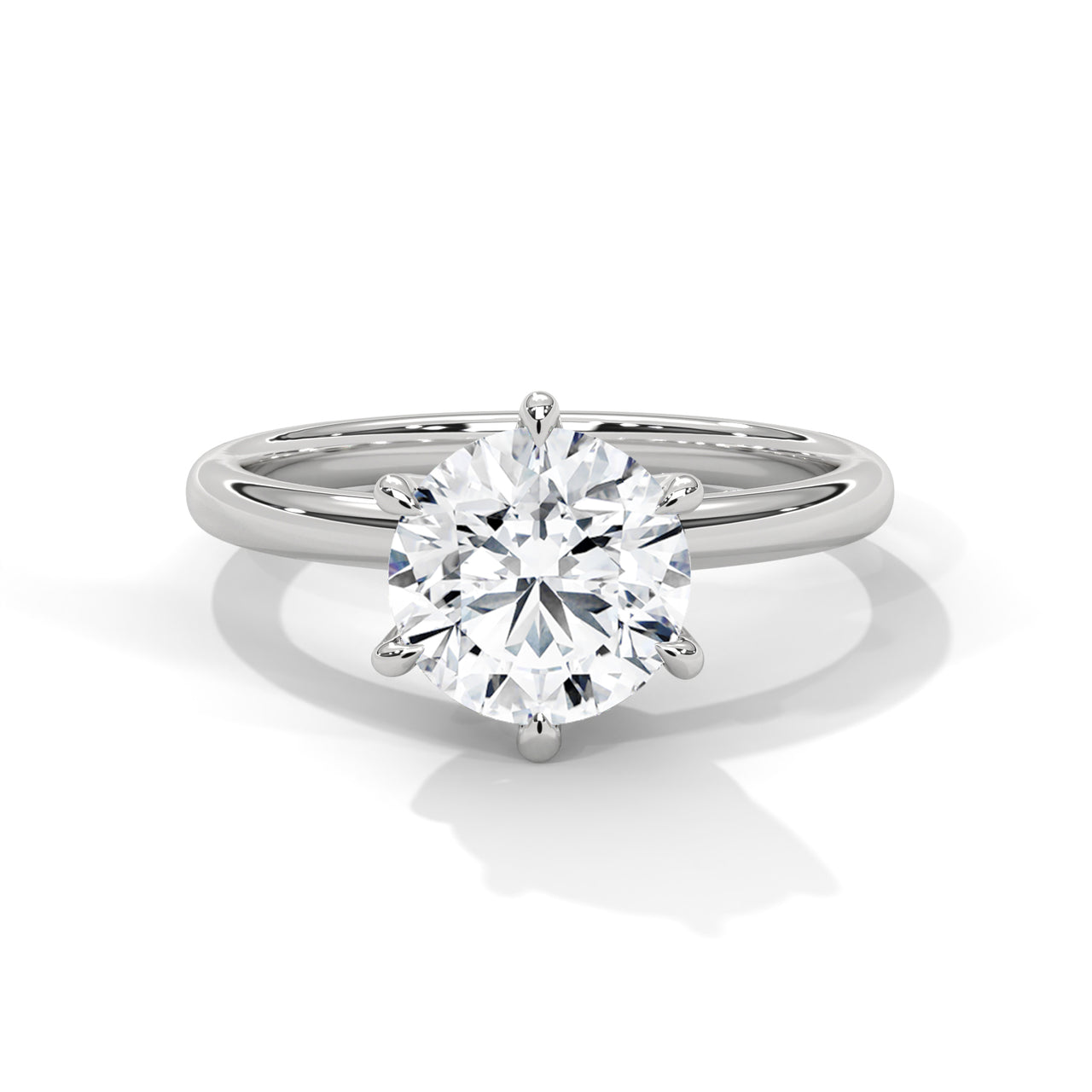 Round brilliant six-prong crown solitaire engagement ring in white gold, side profile view showing hexagonal basket and plain band