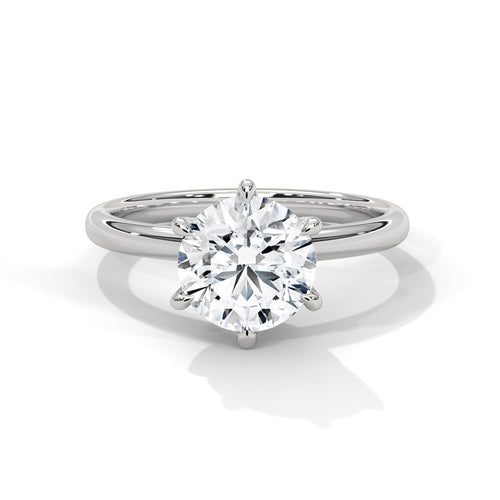 Round brilliant six-prong crown solitaire engagement ring in white gold, side profile view showing hexagonal basket and plain band