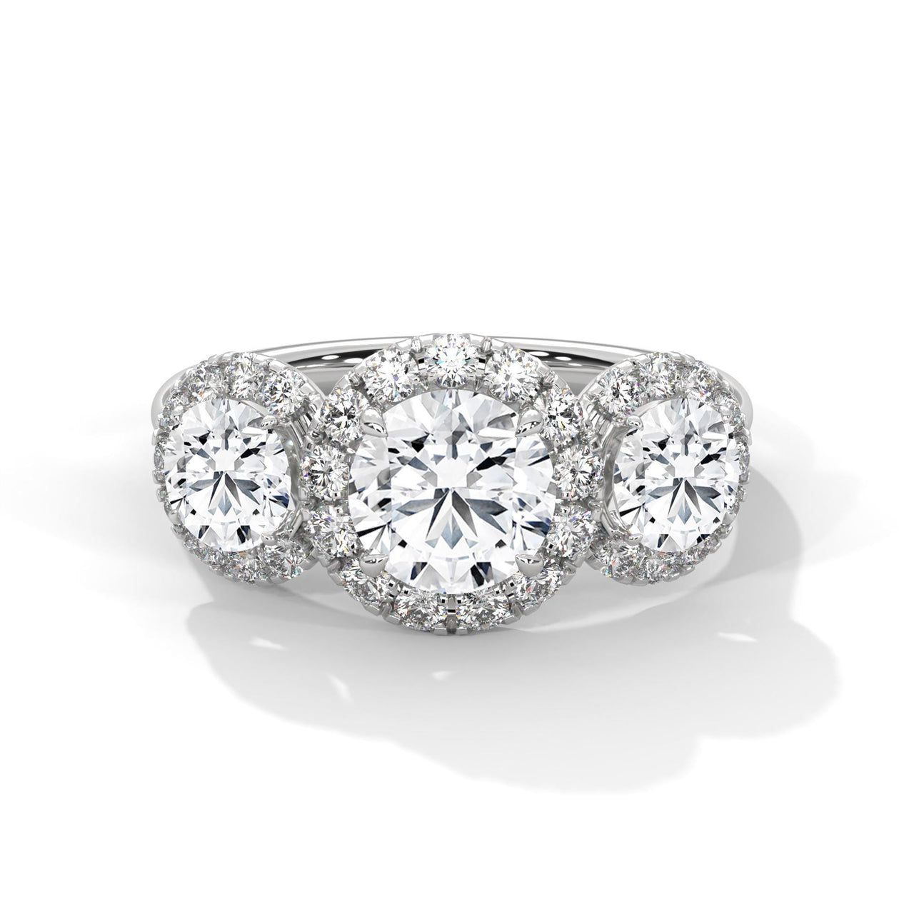 Colorless three-stone round lab diamond halo ring in white gold