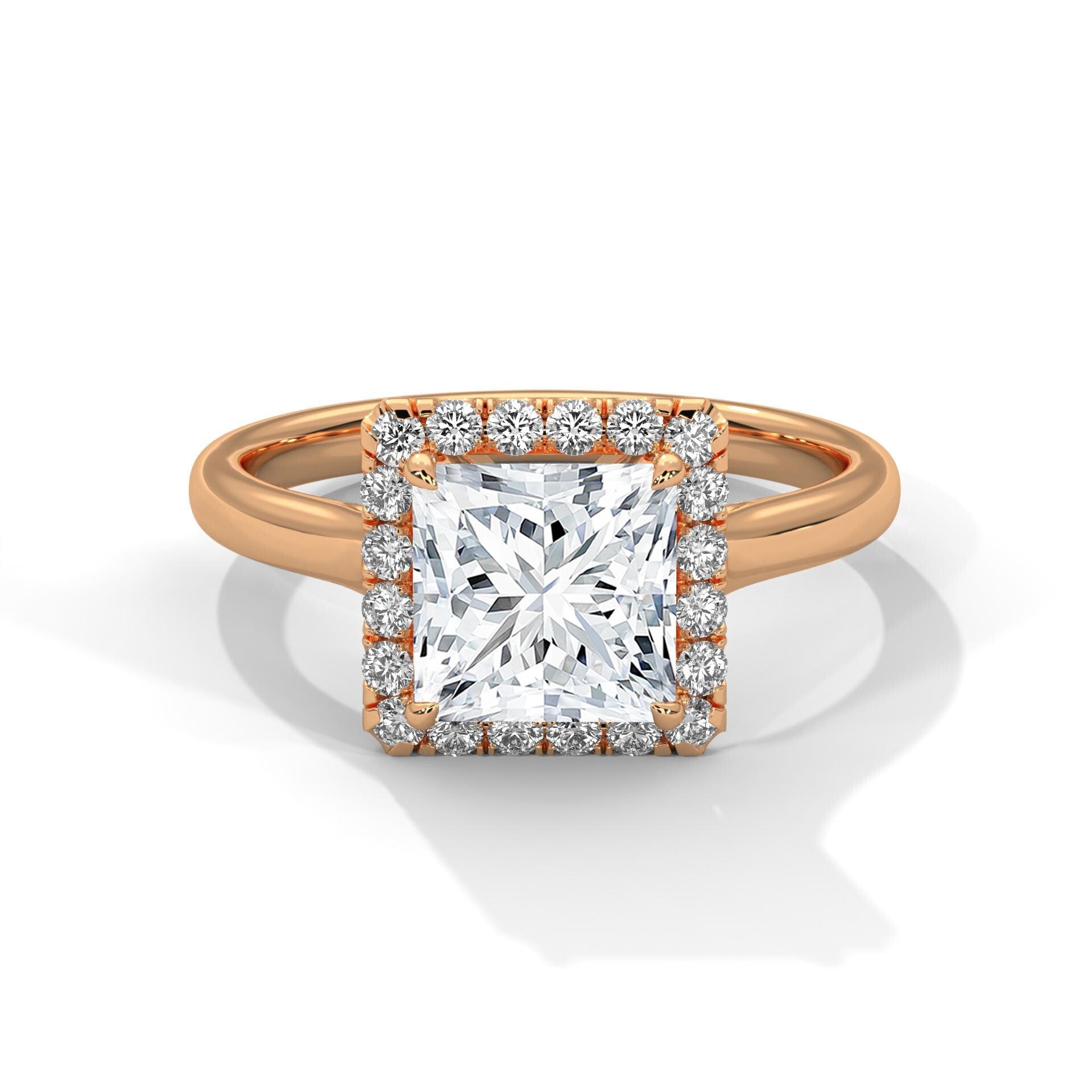 Colorless princess cut lab diamond halo ring in 18K rose gold.