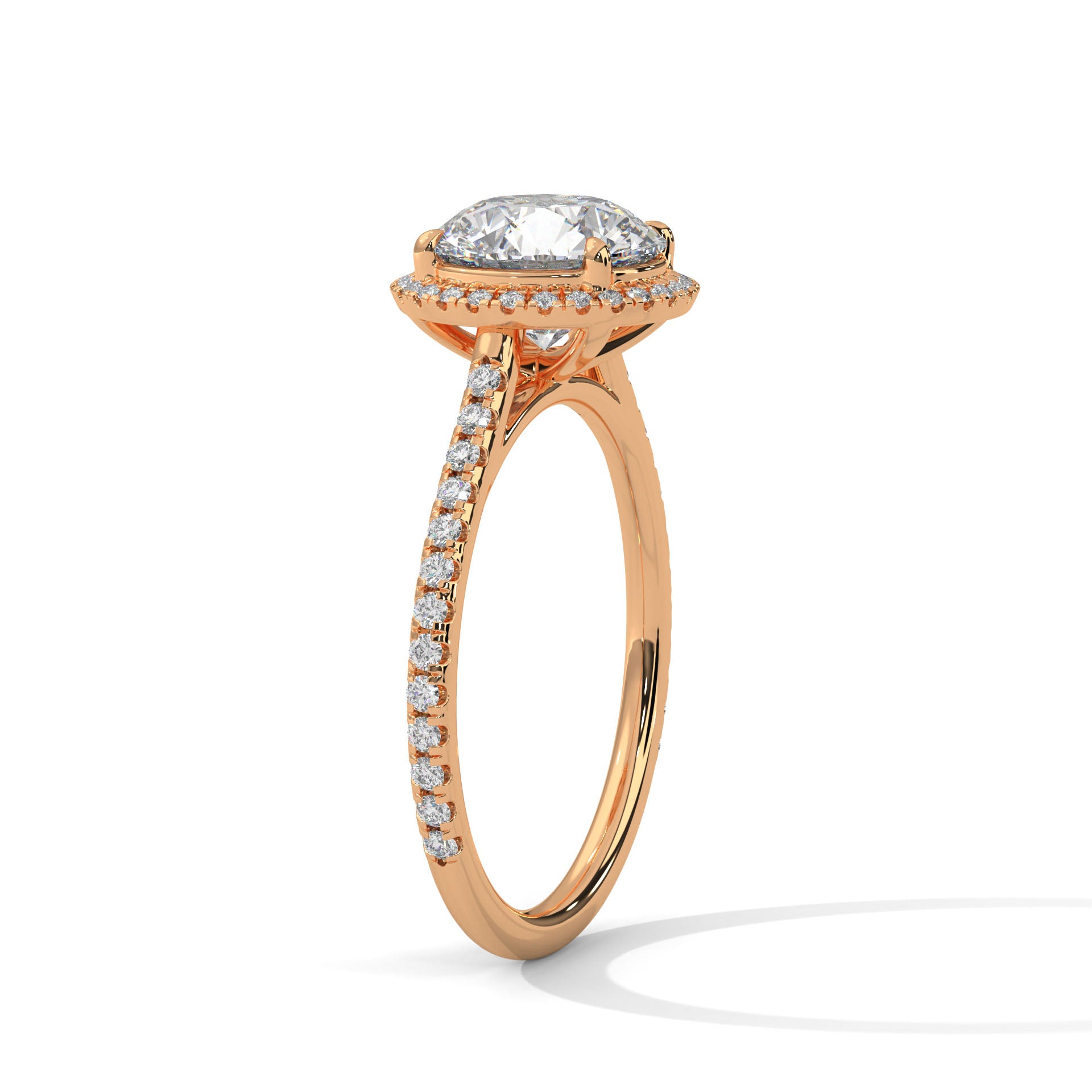 Perspective shot of a round diamond halo and pavé-set band in rose gold.