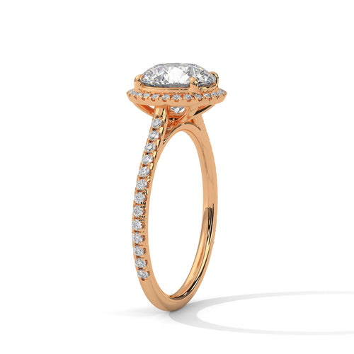Perspective shot of a round diamond halo and pavé-set band in rose gold.