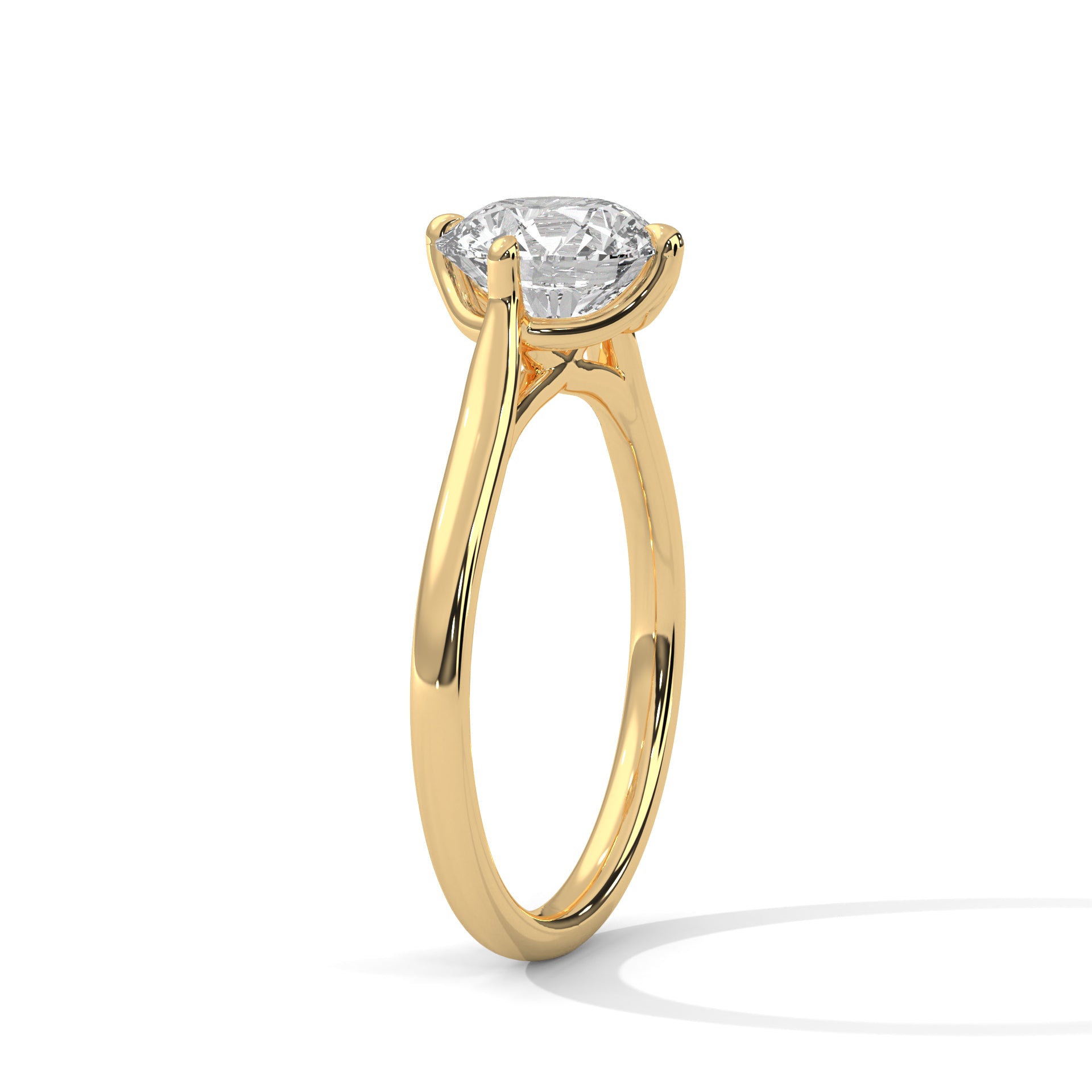 Angled perspective of a round diamond solitaire ring in yellow gold showcasing the cathedral setting.