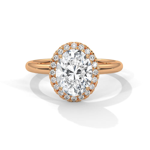 Rose gold oval halo engagement ring featuring a shimmering pavé diamond shank