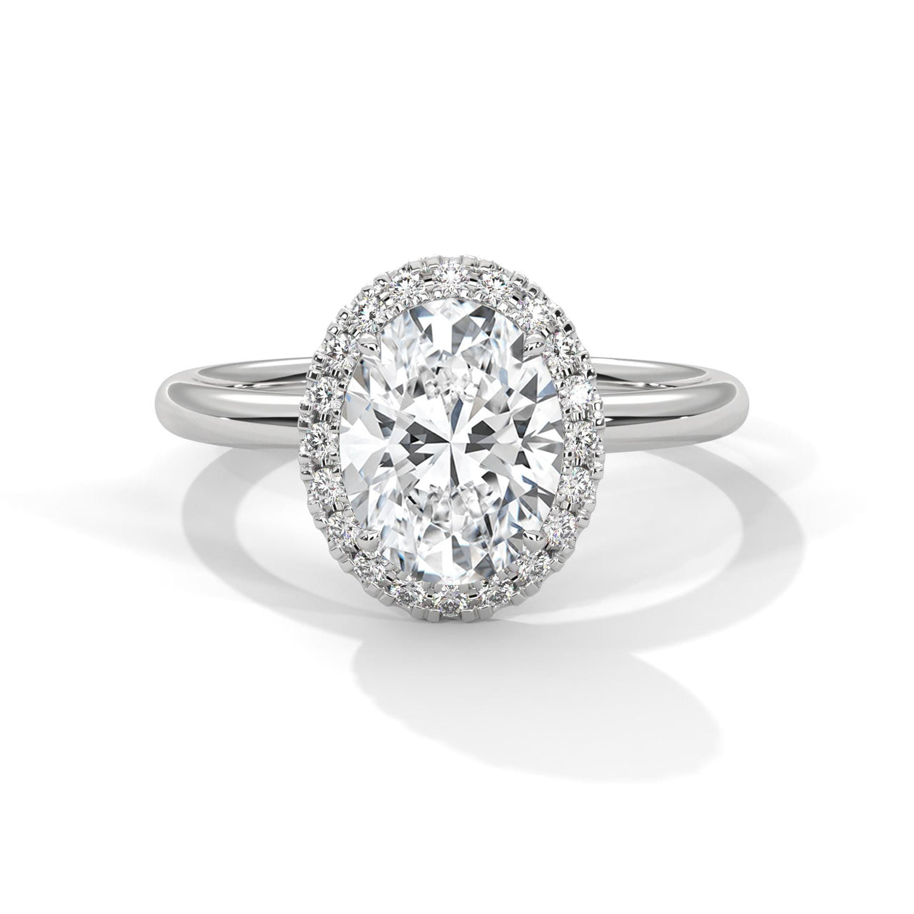 Colorless oval cut lab diamond pave halo ring in white gold