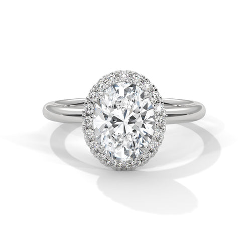 Colorless oval cut lab diamond pave halo ring in white gold