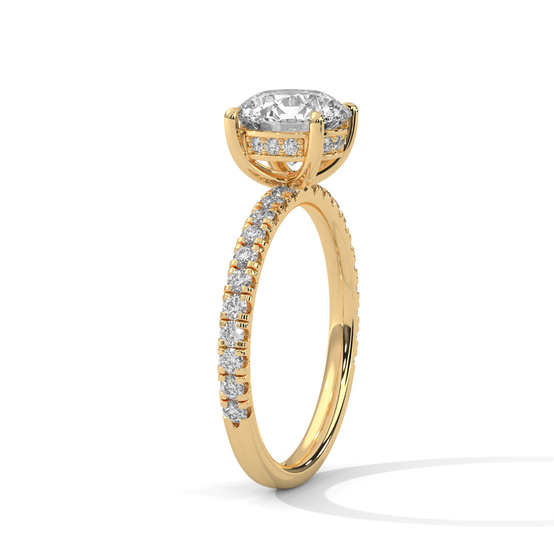 Round brilliant hidden halo pavé engagement ring in yellow gold, angled view showing band and setting