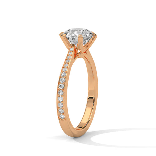 Detailed angled shot of a round diamond and pavé band in rose gold.