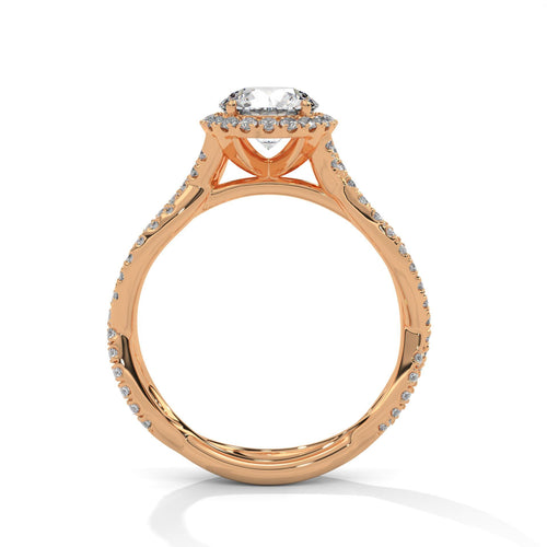 Rose gold round halo ring featuring a shimmering pavé diamond shank.