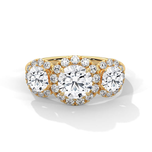 Three-stone round lab grown diamond halo engagement ring in yellow gold