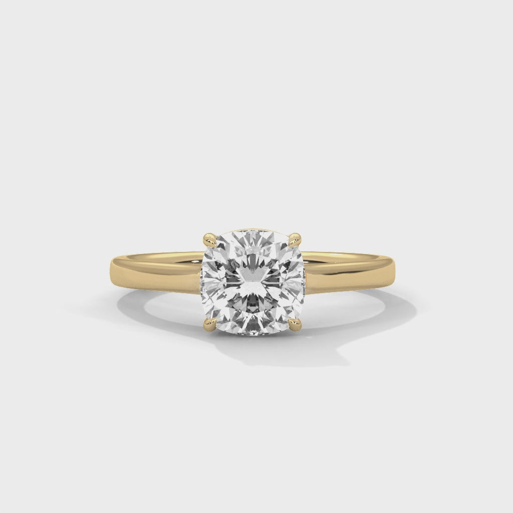 High-definition video showcasing the crisp lines of the knife-edge band, the 360-degree light entry from the open V-gallery, and the fire of the cushion cut lab-grown diamond.