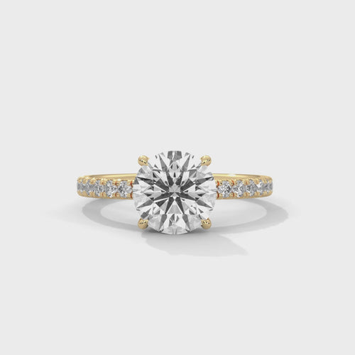 Round brilliant hidden halo pavé engagement ring side profile view highlighting slim band and crown height