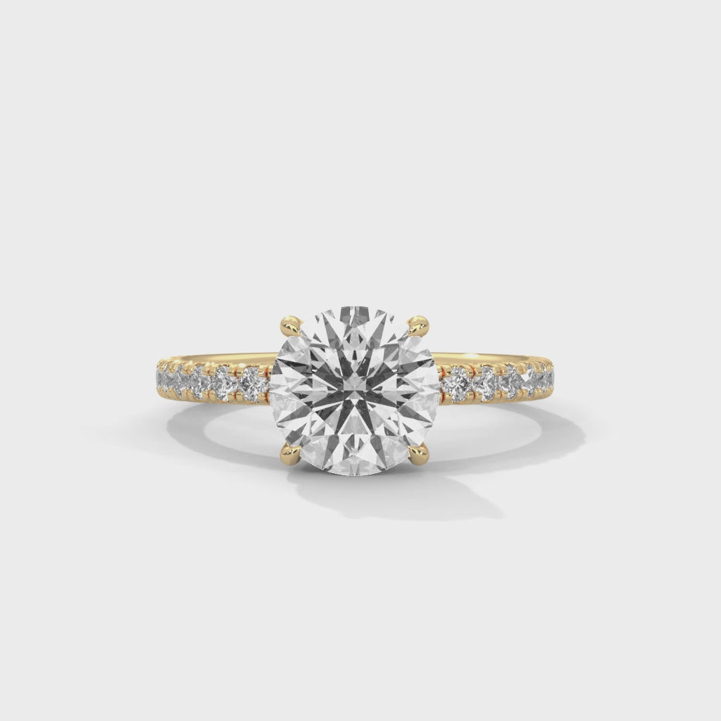 Round brilliant hidden halo pavé engagement ring side profile view highlighting slim band and crown height