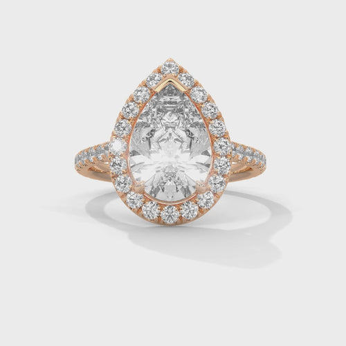 Pear cut bezel-edge floating halo engagement ring in rose gold, top-down view of pear brilliant stone and floating halo