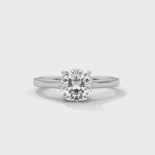 High-definition video showcasing the crisp lines of the knife-edge band, the 360-degree light entry from the open V-gallery, and the fire of the cushion cut lab-grown diamond.