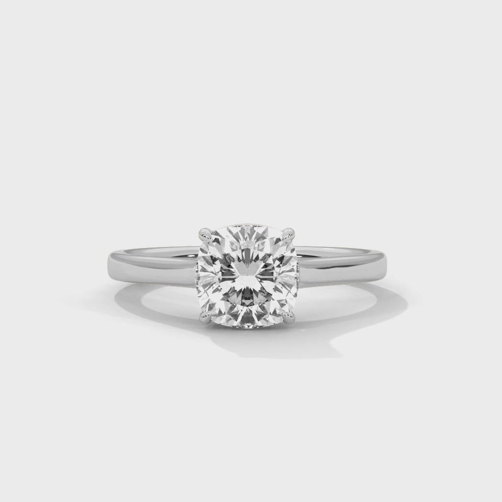 High-definition video showcasing the crisp lines of the knife-edge band, the 360-degree light entry from the open V-gallery, and the fire of the cushion cut lab-grown diamond.