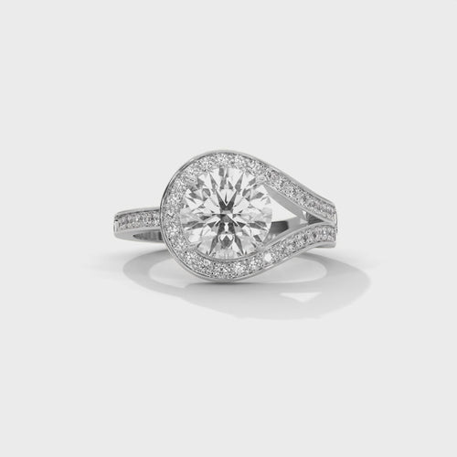Round brilliant bypass split halo engagement ring in white gold, overhead view of round brilliant center stone and bypass halo detail