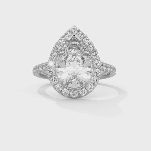 Pear cut bezel-edge floating halo engagement ring in white gold, side profile view showing cathedral columns and French pavé band