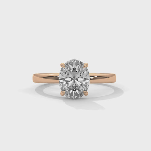 Oval solitaire plain band engagement ring in rose gold, top-down view of oval center stone and plain band